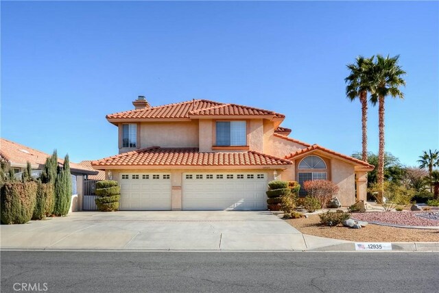 mediterranean / spanish home with a garage