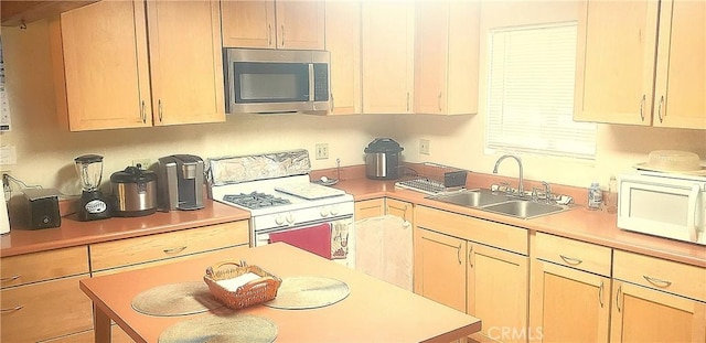 kitchen with sink, white appliances, and light brown cabinets