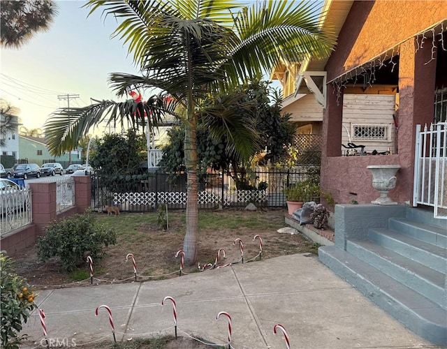 yard at dusk featuring a patio