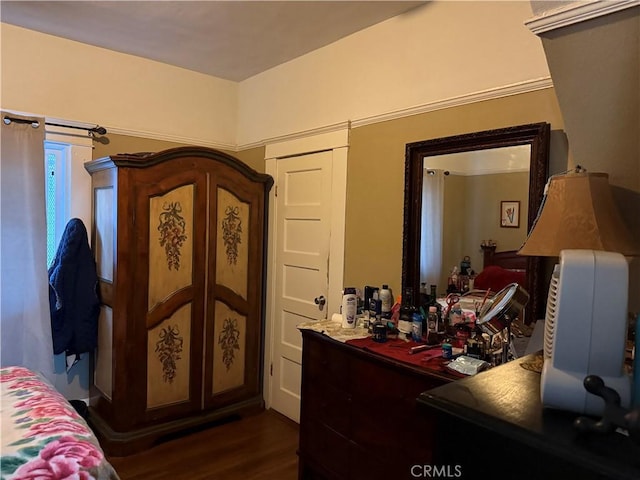 bedroom featuring bar area and dark hardwood / wood-style floors