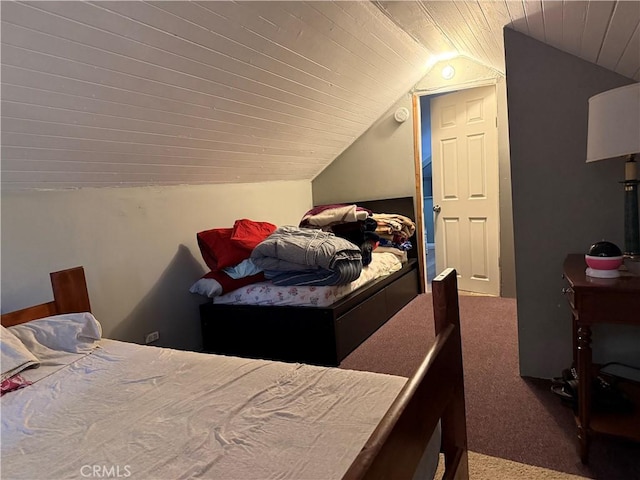 bedroom featuring lofted ceiling and carpet flooring