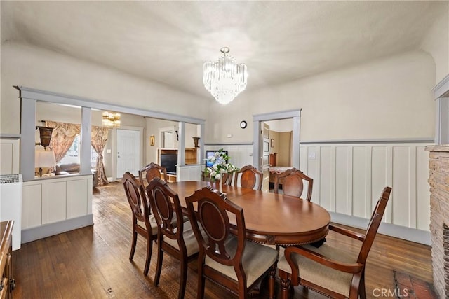 dining room featuring an inviting chandelier and dark hardwood / wood-style floors