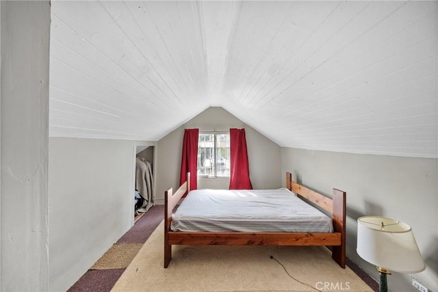 bedroom with vaulted ceiling and carpet