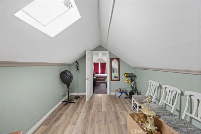 bonus room featuring light hardwood / wood-style flooring and lofted ceiling with skylight