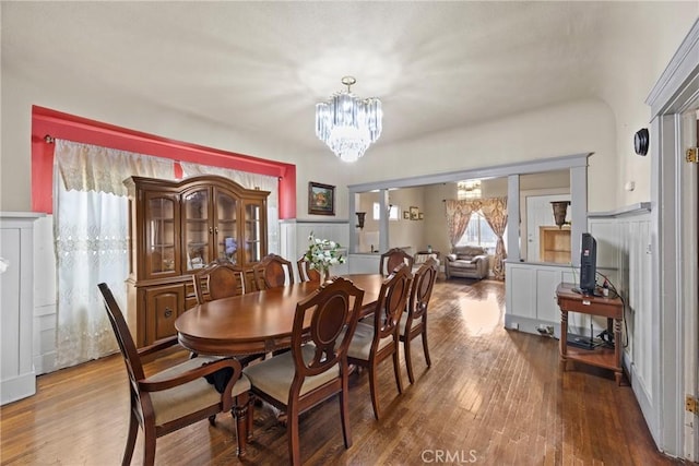 dining space with an inviting chandelier and hardwood / wood-style flooring