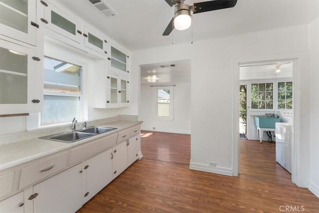 kitchen with dark wood-type flooring, sink, and white cabinetry