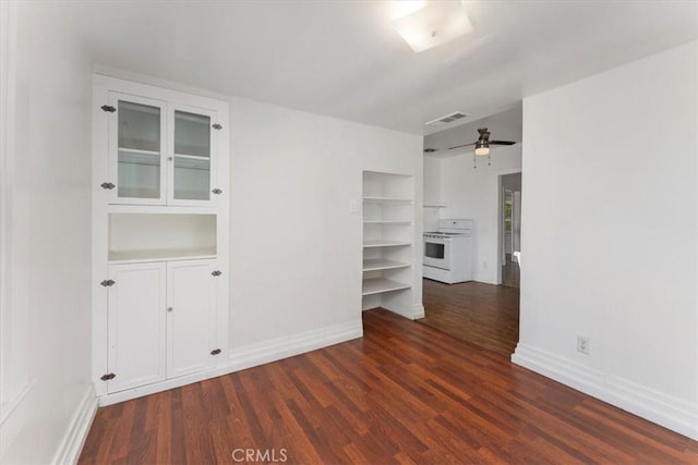 empty room with ceiling fan and dark hardwood / wood-style floors