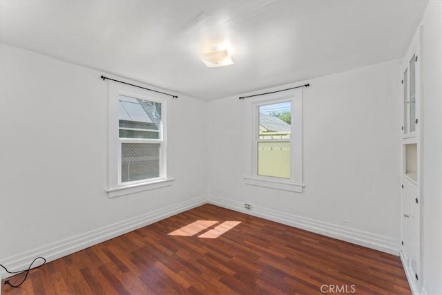 unfurnished room featuring dark wood-type flooring