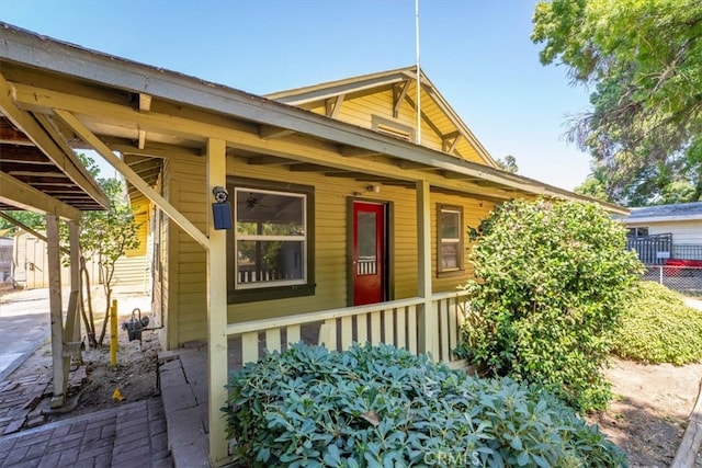 view of side of property featuring covered porch