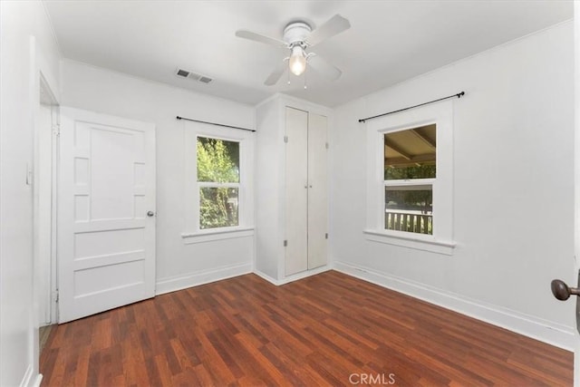 spare room with ceiling fan and dark hardwood / wood-style floors