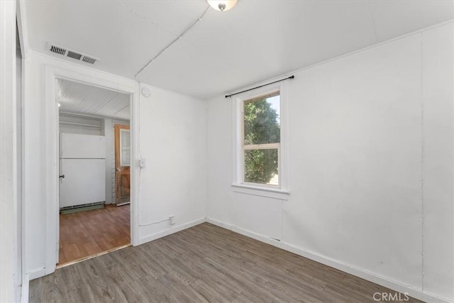 empty room with hardwood / wood-style flooring