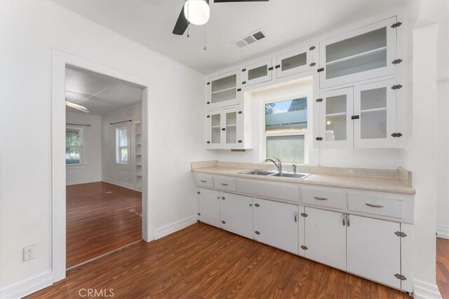 kitchen with ceiling fan, white cabinets, dark wood-type flooring, and sink