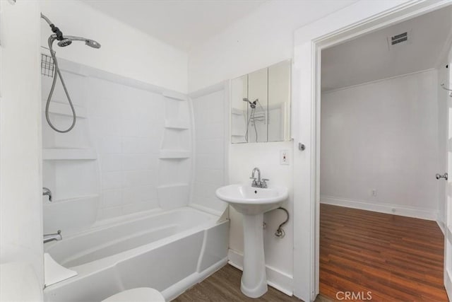 bathroom with sink, hardwood / wood-style floors, and shower / bathing tub combination