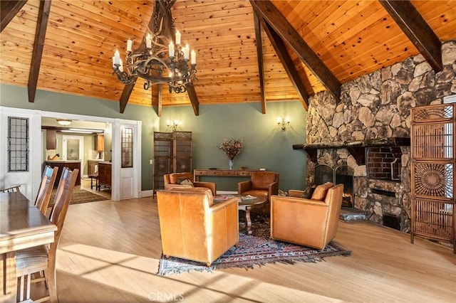 living room with a stone fireplace, wooden ceiling, high vaulted ceiling, beam ceiling, and light hardwood / wood-style flooring