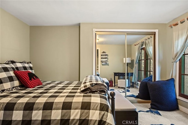 bedroom with light colored carpet and a closet