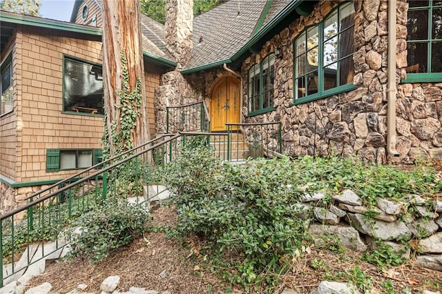 801 Kuffel Canyon Rd, Lake Arrowhead, CA 92385 - doorway to property featuring roof with shingles and stone siding