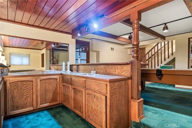 801 Kuffel Canyon Rd, Lake Arrowhead, CA 92385 - kitchen featuring dark carpet, rail lighting, wood ceiling, brown cabinets, and light countertops