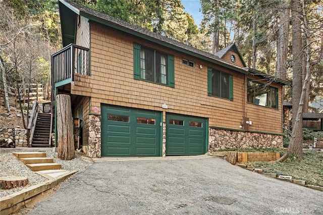 801 Kuffel Canyon Rd, Lake Arrowhead, CA 92385 - chalet / cabin with a garage, driveway, stairs, and stone siding
