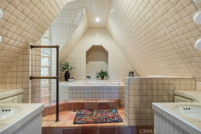 bathroom with vaulted ceiling, tile walls, a relaxing tiled tub, and vanity