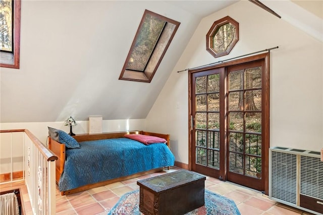 bedroom with light tile patterned floors and lofted ceiling with skylight