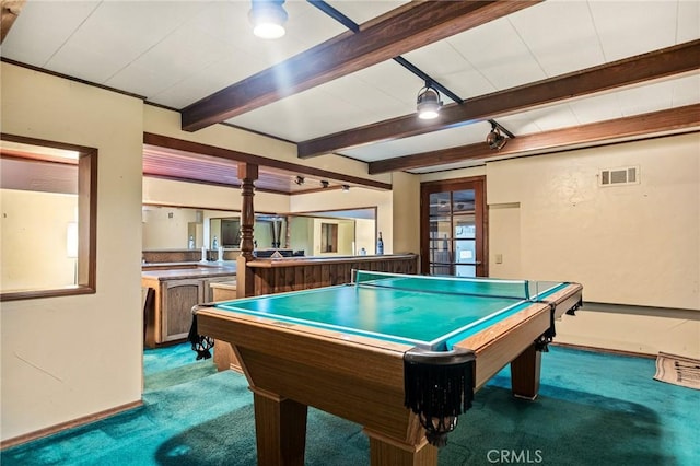 game room featuring beam ceiling and carpet