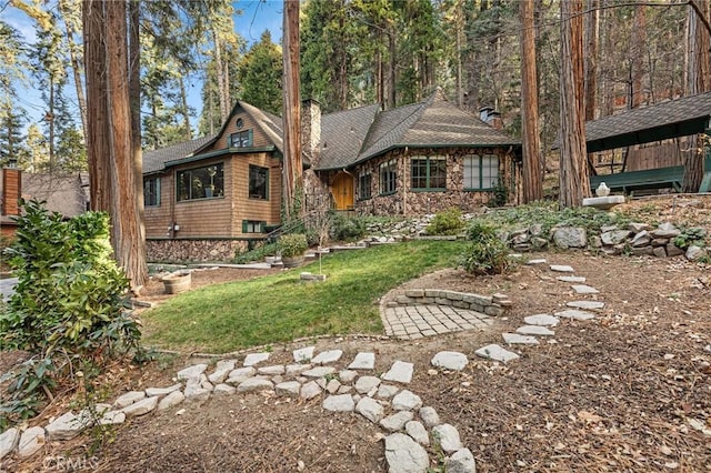 801 Kuffel Canyon Rd, Lake Arrowhead, CA 92385 - view of front facade with a chimney, stone siding, a front lawn, and a shingled roof