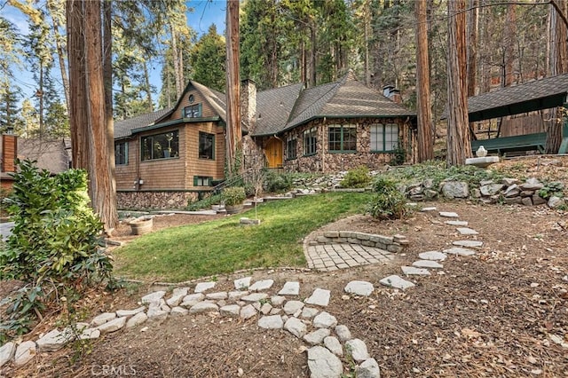 801 Kuffel Canyon Rd, Lake Arrowhead, CA 92385 - view of front of home featuring stone siding, a chimney, a front yard, and a shingled roof