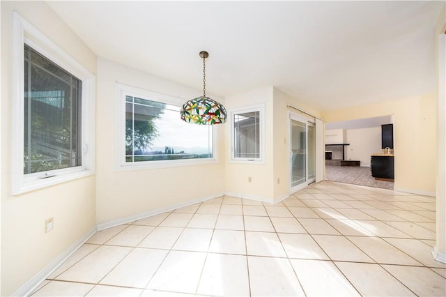 unfurnished dining area with light tile patterned flooring