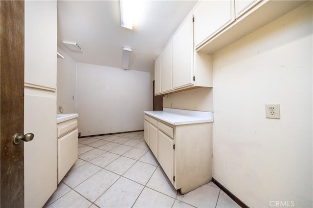 kitchen with white cabinets and light tile patterned flooring