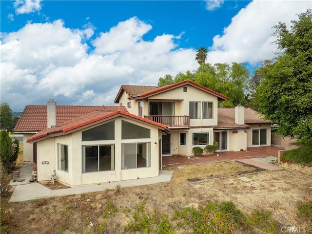 rear view of house featuring a balcony