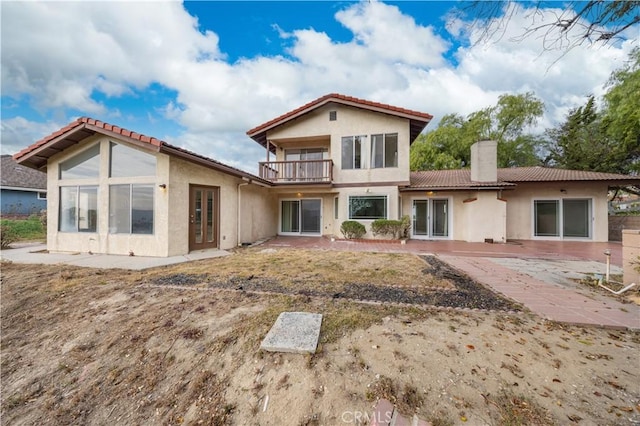 back of property with a patio area and a balcony