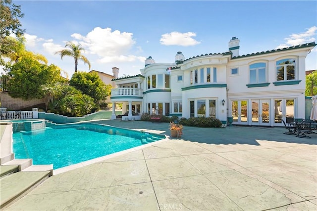 view of pool with a patio area and french doors