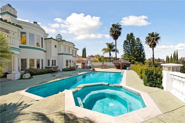 view of pool with an in ground hot tub and a gazebo