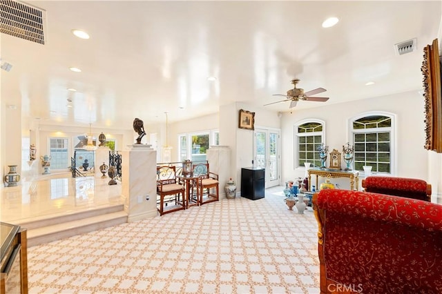 carpeted living room featuring ceiling fan