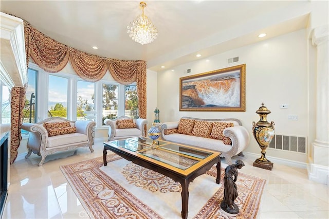 living area featuring decorative columns and an inviting chandelier