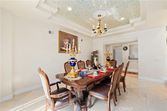 dining area featuring a tray ceiling and an inviting chandelier