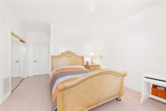 bedroom with hardwood / wood-style floors and a closet