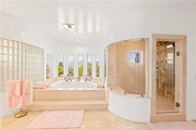 bathroom with tile patterned floors and separate shower and tub