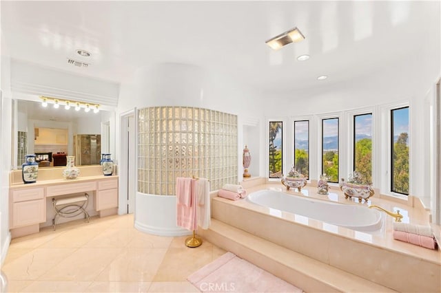 bathroom featuring vanity, tile patterned floors, and a bathing tub