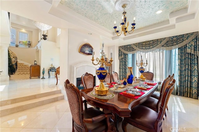 dining room featuring a textured ceiling, a raised ceiling, a chandelier, and light tile patterned flooring