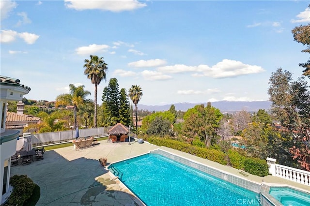 view of pool featuring a patio area, a mountain view, and a gazebo