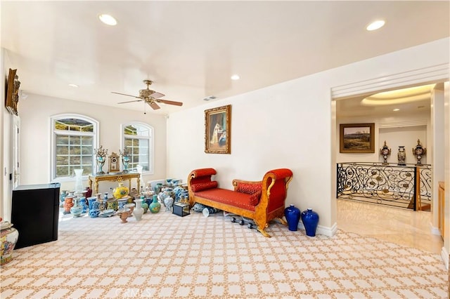 living area featuring ceiling fan and light carpet