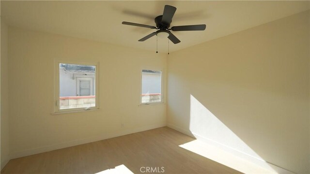 empty room with ceiling fan and hardwood / wood-style floors