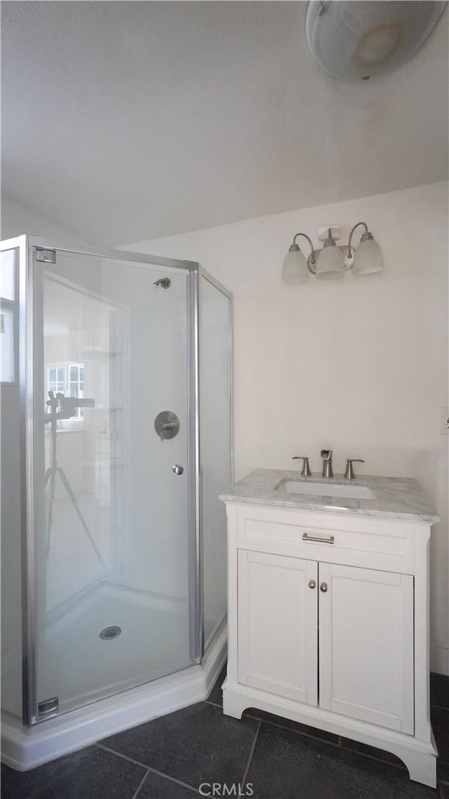 bathroom with vanity, a shower with door, and tile patterned floors