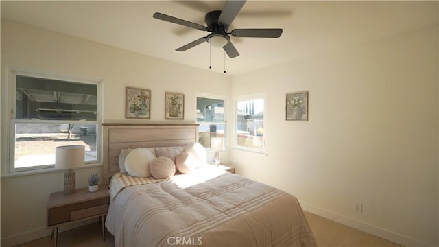 bedroom with ceiling fan and hardwood / wood-style flooring