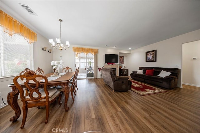 dining area with a chandelier and hardwood / wood-style flooring