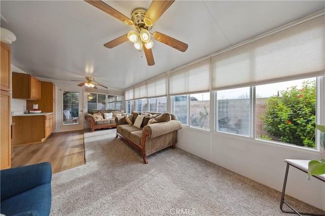 sunroom / solarium featuring ceiling fan