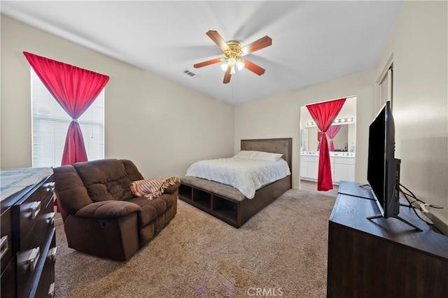 bedroom with ceiling fan, carpet, and connected bathroom