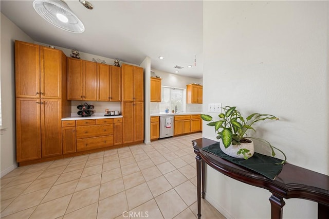 kitchen featuring sink, light tile patterned floors, and dishwasher