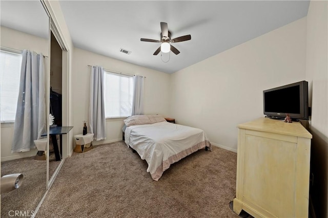 bedroom with ceiling fan, a closet, and carpet floors